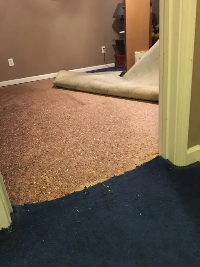 Carpet pad removal revealing water damage during Drying & Dehumidification in Joshua Tree