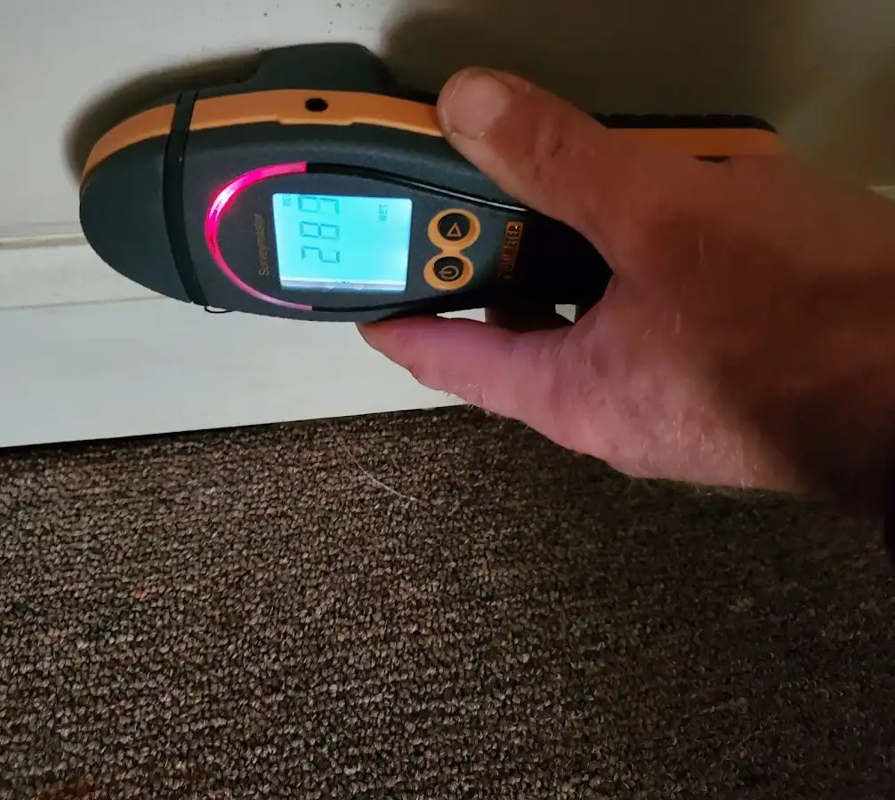 Moisture detection at baseboard during Storm Damage Restoration in Joshua Tree